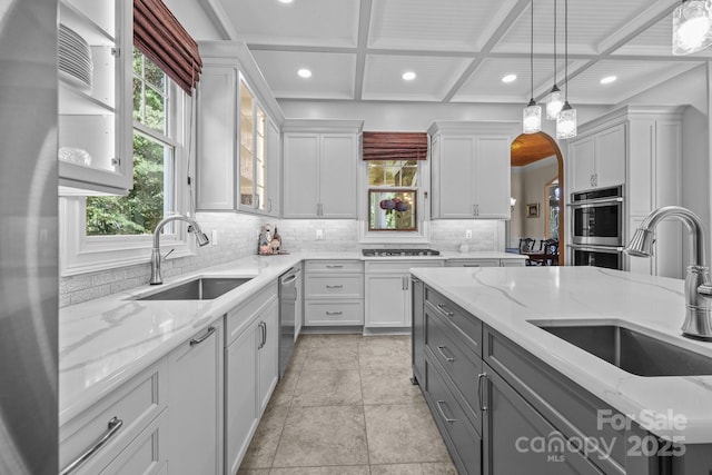123 Yellow Jacket Cir, Mooresville, NC 28117 - kitchen with gray cabinets, coffered ceiling, stainless steel appliances, decorative backsplash, and plenty of natural light