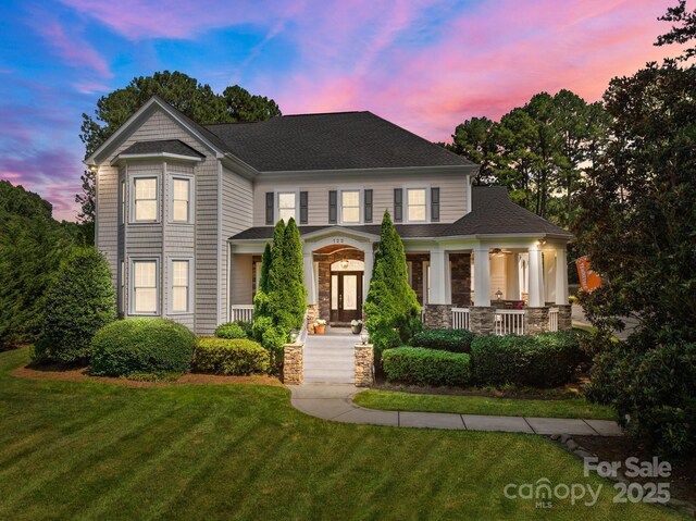 123 Yellow Jacket Cir, Mooresville, NC 28117 - view of front facade featuring a porch, a front lawn, and a shingled roof