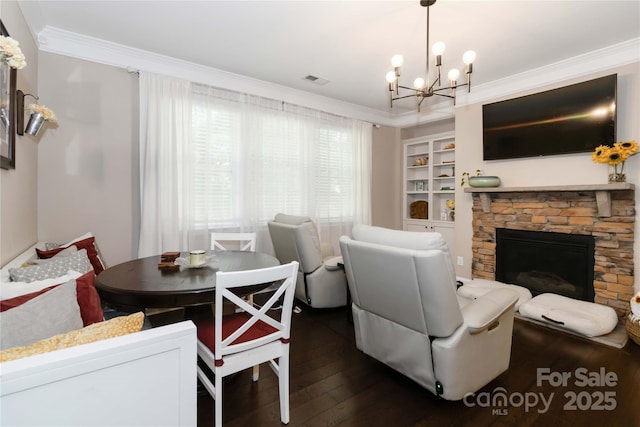 1041 Verbena Ct, Tega Cay, SC 29708 - living area featuring crown molding, dark wood-type flooring, a chandelier, a fireplace, and built in shelves