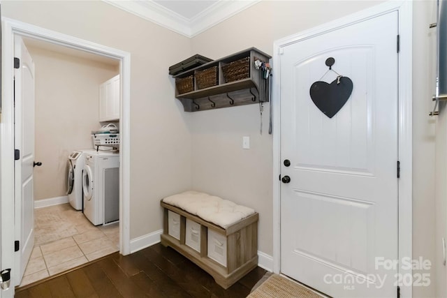 1041 Verbena Ct, Tega Cay, SC 29708 - laundry room featuring cabinet space, washing machine and clothes dryer, ornamental molding, and wood finished floors