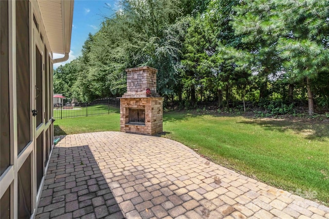 1041 Verbena Ct, Tega Cay, SC 29708 - view of patio featuring an outdoor brick fireplace and view of wooded area
