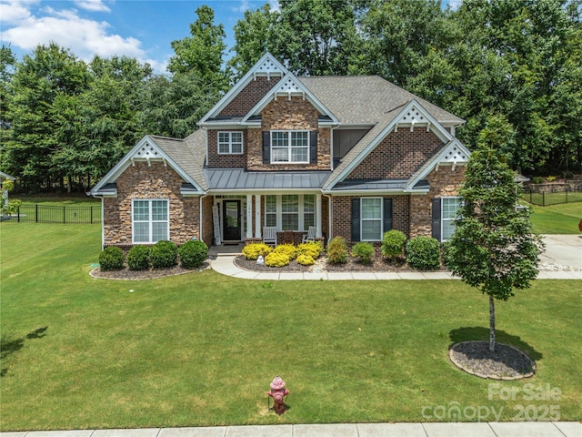 1041 Verbena Ct, Tega Cay, SC 29708 - craftsman inspired home with stone siding, a standing seam roof, covered porch, and roof with shingles