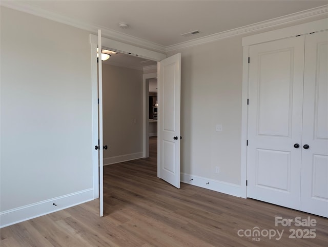 105 Macland Ln Unit 540, Rock Hill, SC 29730 - unfurnished bedroom with light wood finished floors, crown molding, and a closet