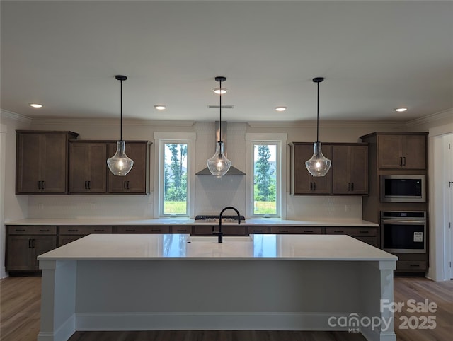 105 Macland Ln Unit 540, Rock Hill, SC 29730 - kitchen featuring stainless steel appliances, wood finished floors, light countertops, dark brown cabinets, and ornamental molding