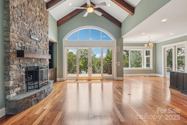 3229 Lake Pointe Dr, Belmont, NC 28012 - unfurnished living room with a stone fireplace, beamed ceiling, wood finished floors, a ceiling fan, and french doors
