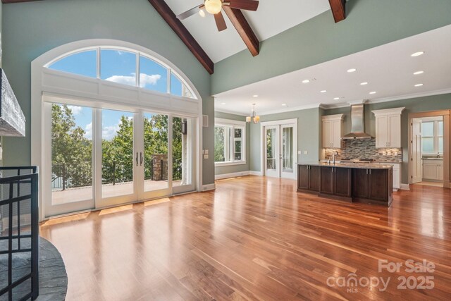 3229 Lake Pointe Dr, Belmont, NC 28012 - unfurnished living room featuring french doors, a ceiling fan, beam ceiling, plenty of natural light, and light wood-type flooring