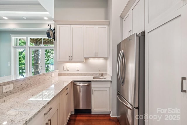 3229 Lake Pointe Dr, Belmont, NC 28012 - kitchen with stainless steel appliances, light stone countertops, dark wood-style flooring, ornamental molding, and white cabinetry