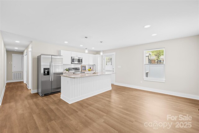 500 N Dr, Cherryville, NC 28021 - kitchen with appliances with stainless steel finishes, white cabinetry, light wood-style flooring, a kitchen island with sink, and recessed lighting