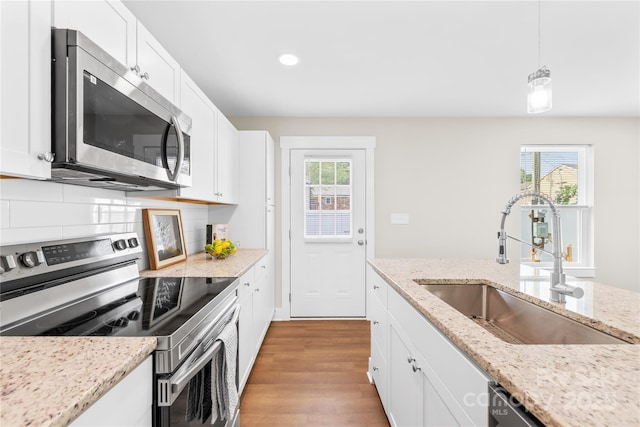 500 N Dr, Cherryville, NC 28021 - kitchen with stainless steel appliances, light wood finished floors, white cabinets, recessed lighting, and pendant lighting