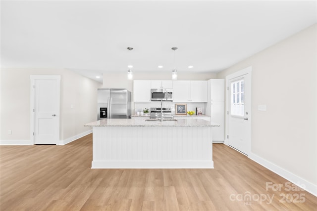 500 N Dr, Cherryville, NC 28021 - kitchen featuring stainless steel appliances, a kitchen island with sink, white cabinetry, light wood finished floors, and recessed lighting