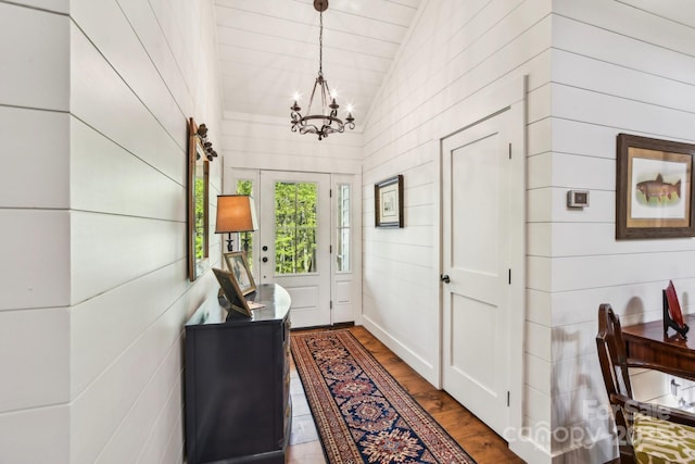 1092 E Bald Rock Dr, Sapphire, NC 28774 - foyer with a chandelier, vaulted ceiling, dark wood finished floors, and wooden walls