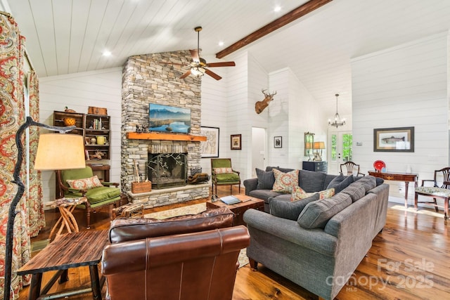 1092 E Bald Rock Dr, Sapphire, NC 28774 - living area featuring wood finished floors, a ceiling fan, a chandelier, wood walls, and a stone fireplace