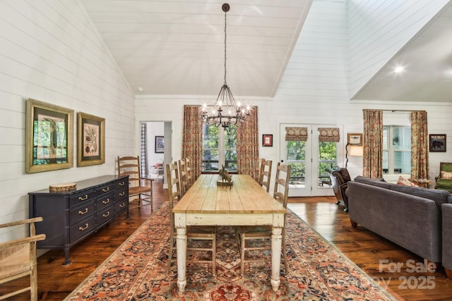 1092 E Bald Rock Dr, Sapphire, NC 28774 - dining space featuring dark wood-type flooring, a chandelier, high vaulted ceiling, wooden walls, and french doors