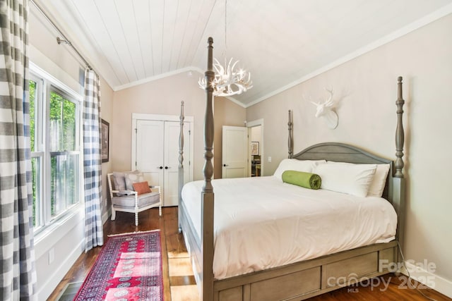 1092 E Bald Rock Dr, Sapphire, NC 28774 - bedroom with crown molding, vaulted ceiling, a closet, dark wood-style flooring, and a chandelier