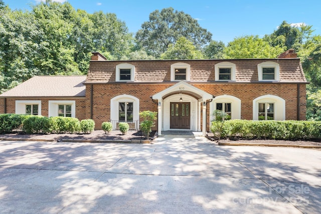 630 Burrage Rd NE, Concord, NC 28025 - front facade featuring a chimney, brick siding, mansard roof, and a shingled roof