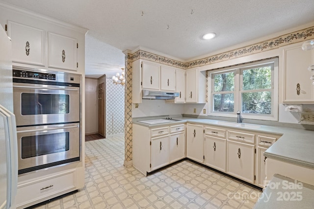 630 Burrage Rd NE, Concord, NC 28025 - kitchen with double oven, under cabinet range hood, light countertops, a textured ceiling, and light floors