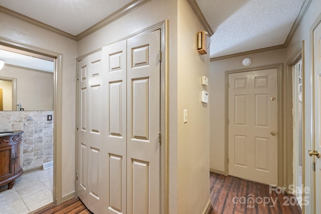 630 Burrage Rd NE, Concord, NC 28025 - corridor with a textured ceiling, ornamental molding, and dark wood-style flooring