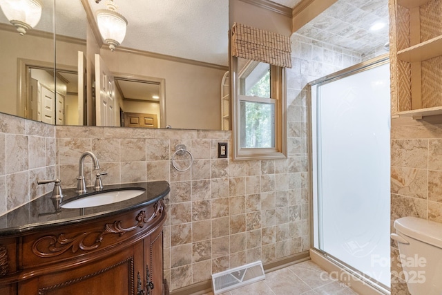 630 Burrage Rd NE, Concord, NC 28025 - full bathroom featuring tile walls, ornamental molding, a stall shower, vanity, and tile patterned floors