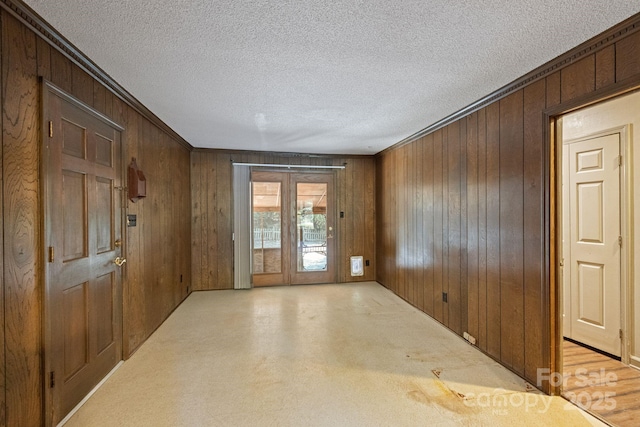 630 Burrage Rd NE, Concord, NC 28025 - unfurnished room featuring wooden walls and a textured ceiling