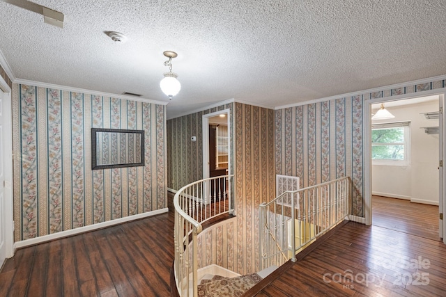 630 Burrage Rd NE, Concord, NC 28025 - hallway featuring an upstairs landing, hardwood / wood-style flooring, ornamental molding, and a textured ceiling
