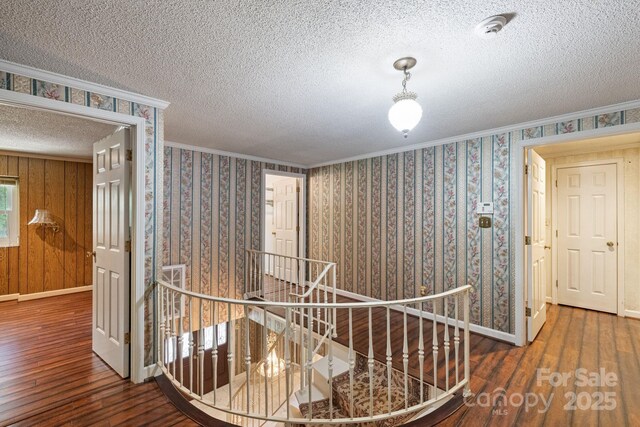 630 Burrage Rd NE, Concord, NC 28025 - hallway with an upstairs landing, wood finished floors, a textured ceiling, and crown molding