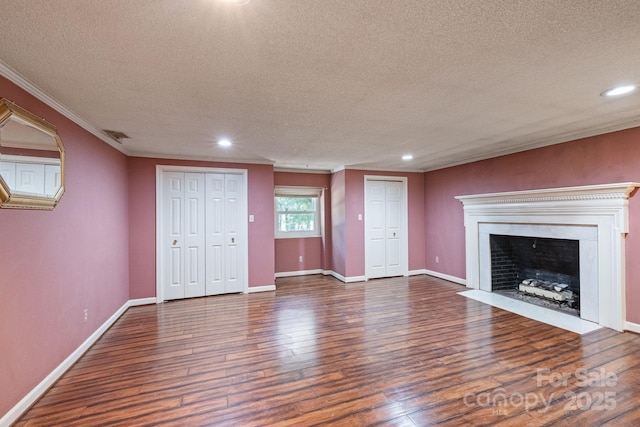 630 Burrage Rd NE, Concord, NC 28025 - unfurnished living room with a textured ceiling, ornamental molding, wood finished floors, recessed lighting, and a fireplace with flush hearth