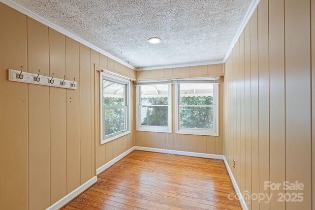 630 Burrage Rd NE, Concord, NC 28025 - spare room with light wood-style flooring, crown molding, and a textured ceiling