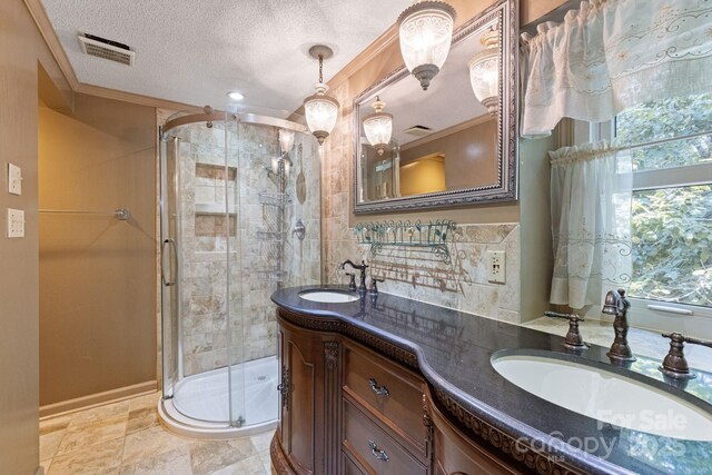 630 Burrage Rd NE, Concord, NC 28025 - full bath with double vanity, a shower stall, ornamental molding, and a textured ceiling