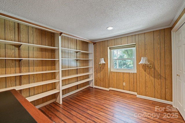 630 Burrage Rd NE, Concord, NC 28025 - unfurnished room featuring a textured ceiling, wood finished floors, and wooden walls
