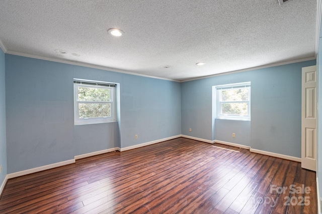 630 Burrage Rd NE, Concord, NC 28025 - spare room with crown molding, healthy amount of natural light, a textured ceiling, dark wood finished floors, and recessed lighting