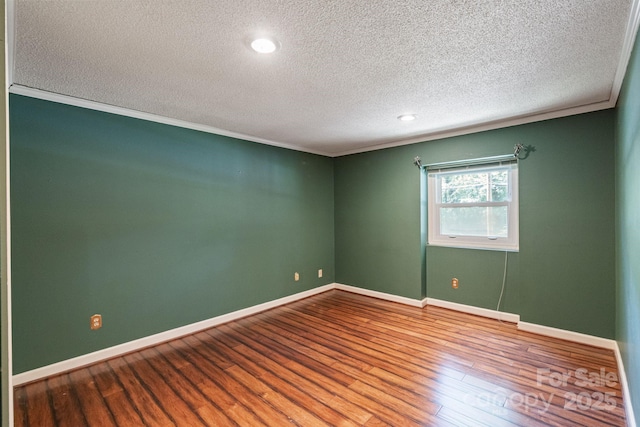 630 Burrage Rd NE, Concord, NC 28025 - spare room with a textured ceiling, wood finished floors, crown molding, and recessed lighting