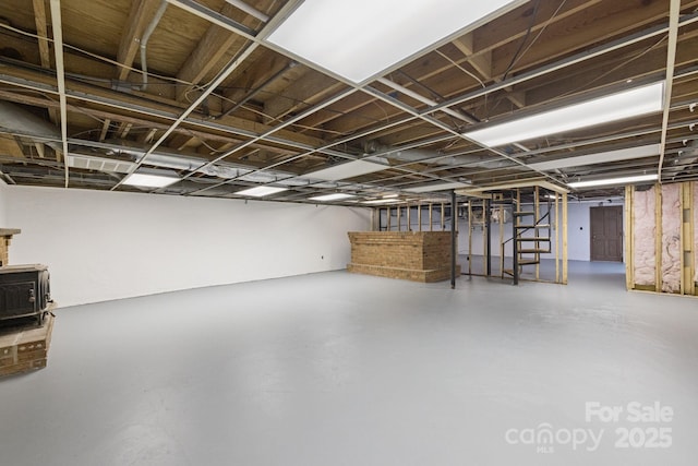 630 Burrage Rd NE, Concord, NC 28025 - unfinished basement featuring a wood stove