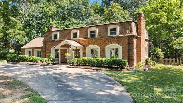 630 Burrage Rd NE, Concord, NC 28025 - view of front of home featuring a chimney, mansard roof, and brick siding
