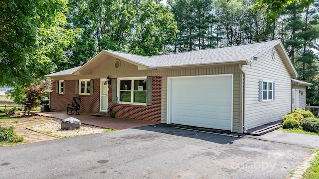 309 Sheldon St, Hudson, NC 28638 - single story home with an attached garage, brick siding, asphalt driveway, and a shingled roof