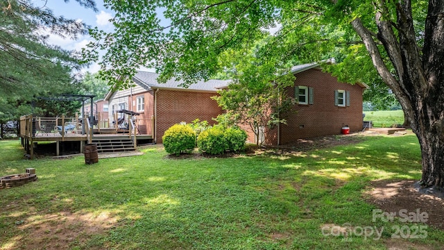 309 Sheldon St, Hudson, NC 28638 - view of side of property featuring a deck, a lawn, and brick siding