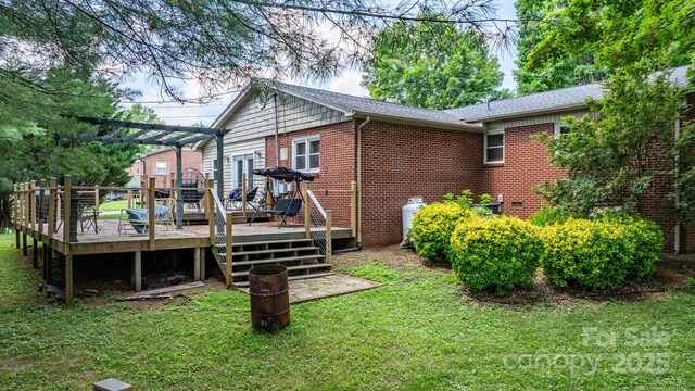 309 Sheldon St, Hudson, NC 28638 - back of house featuring a pergola, a lawn, a wooden deck, and brick siding