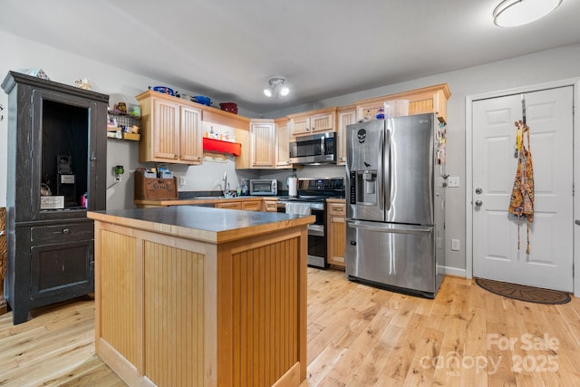 309 Sheldon St, Hudson, NC 28638 - kitchen with appliances with stainless steel finishes, light wood-style floors, dark countertops, and light brown cabinetry