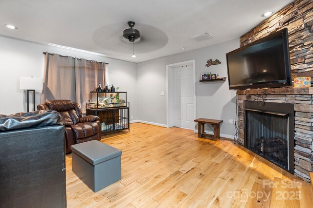 309 Sheldon St, Hudson, NC 28638 - living area featuring ceiling fan, wood finished floors, a stone fireplace, and recessed lighting