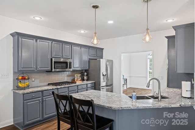 1528 Autumn Brook Ln, York, SC 29745 - kitchen with appliances with stainless steel finishes, gray cabinets, decorative backsplash, dark wood-style flooring, and a peninsula