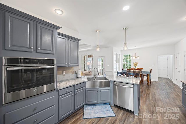 1528 Autumn Brook Ln, York, SC 29745 - kitchen with appliances with stainless steel finishes, a peninsula, dark wood-type flooring, backsplash, and gray cabinets