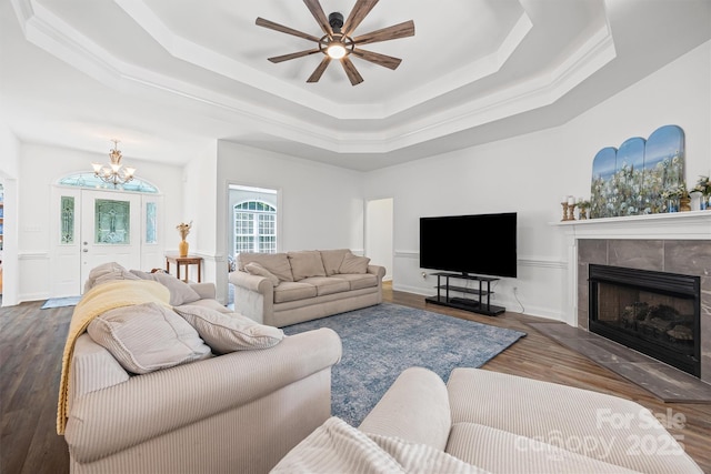 1528 Autumn Brook Ln, York, SC 29745 - living room featuring a tray ceiling, a fireplace, a chandelier, a ceiling fan, and wood finished floors