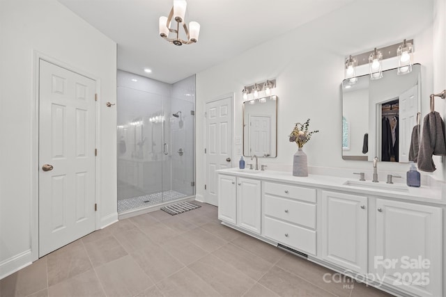 1528 Autumn Brook Ln, York, SC 29745 - full bathroom with double vanity, a stall shower, a chandelier, a closet, and tile patterned floors