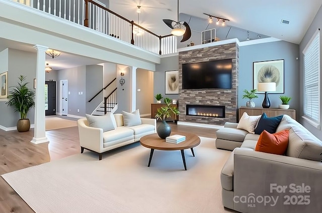 5237 Afterglow Ave, Concord, NC 28025 - living room with decorative columns, wood finished floors, plenty of natural light, and high vaulted ceiling