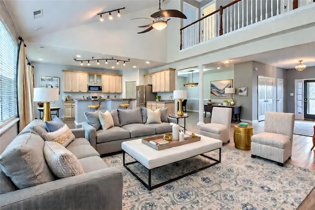 5237 Afterglow Ave, Concord, NC 28025 - living area with track lighting, ceiling fan, light wood-type flooring, and high vaulted ceiling