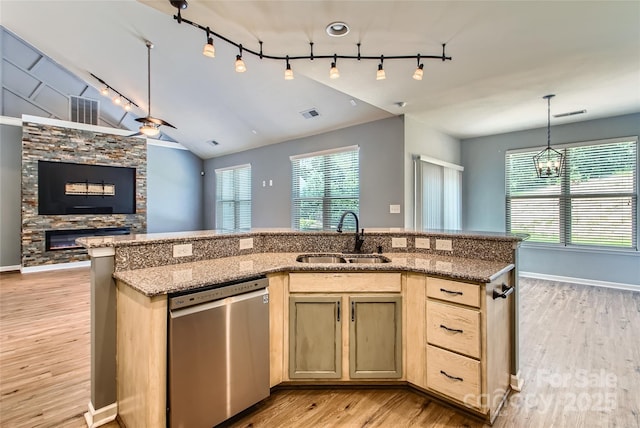 5237 Afterglow Ave, Concord, NC 28025 - kitchen with stainless steel dishwasher, rail lighting, open floor plan, light wood-style flooring, and a fireplace