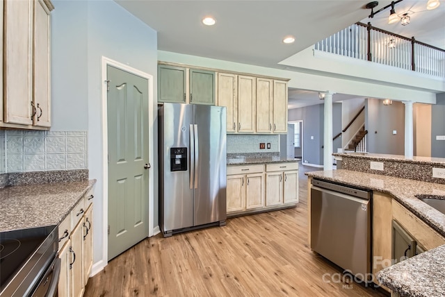 5237 Afterglow Ave, Concord, NC 28025 - kitchen with appliances with stainless steel finishes, light wood-style floors, decorative columns, tasteful backsplash, and light stone counters