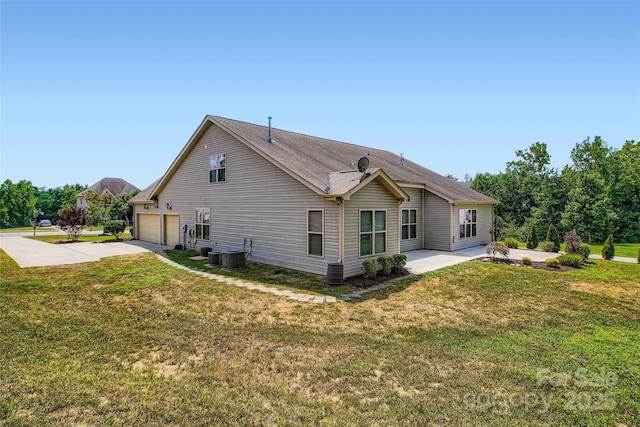 5237 Afterglow Ave, Concord, NC 28025 - back of house with a garage, driveway, a lawn, and a patio