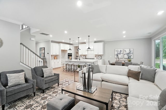 9945 Cask Way, Huntersville, NC 28078 - living area with recessed lighting, ornamental molding, stairs, and light wood-style floors
