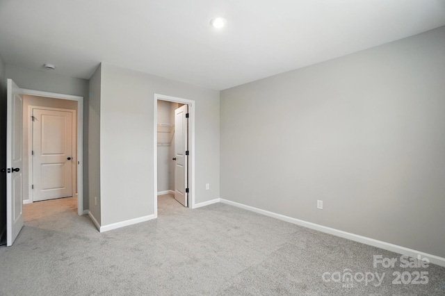 9945 Cask Way, Huntersville, NC 28078 - unfurnished bedroom featuring light colored carpet and a walk in closet
