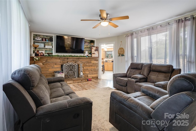 143 W College St, Stanley, NC 28164 - living room with ceiling fan, wood finished floors, and a stone fireplace